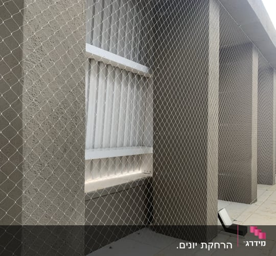 רשת למניעת כניסת יונים על קיר חיצוני